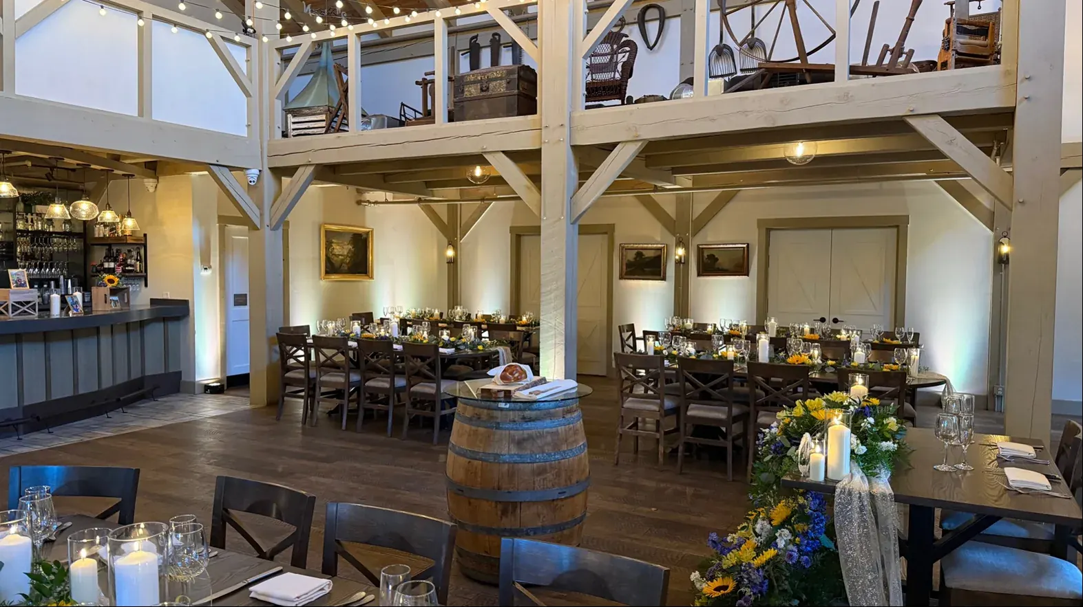 Reception tables, string lights, and uplighting at Grove at Briar Barn Inn in Rowley